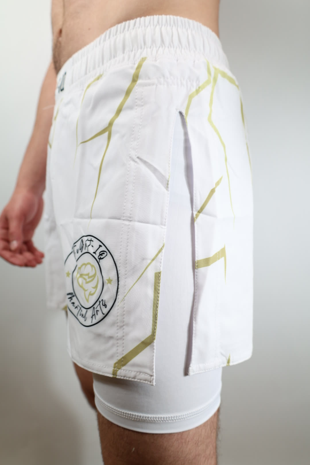 RAGE GUARD white and gold rashguard, three-quarter view